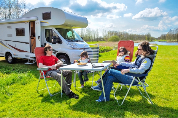 Family using a tablet to book an RV park online, representing future local marketing trends for RV parks.